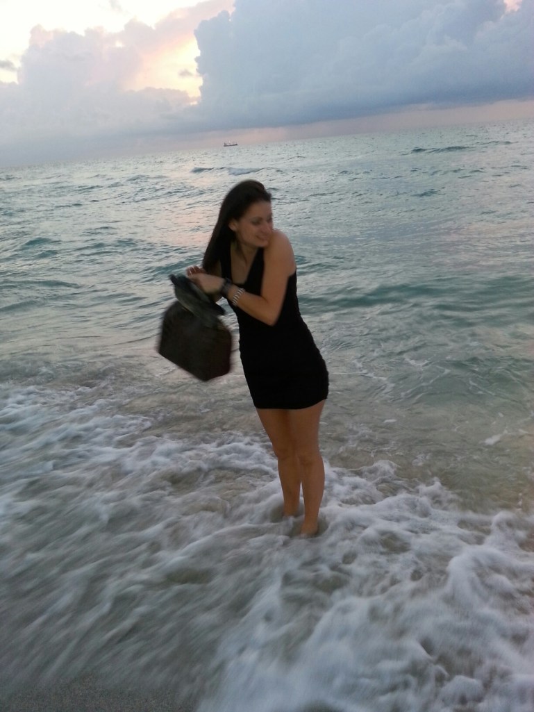 Trying to keep the purse dry, but hardly caring because the water was so warm. 